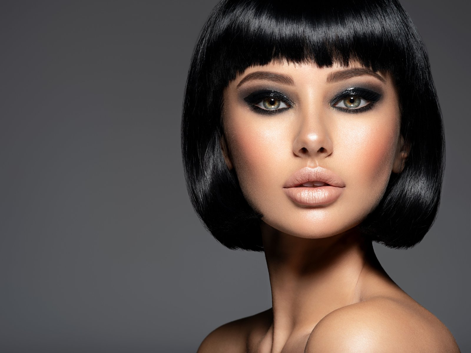 Beautiful fashion woman with a bob hairstyle looks to the camera